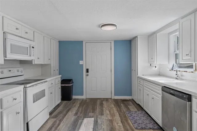 a kitchen with a sink stove and cabinets