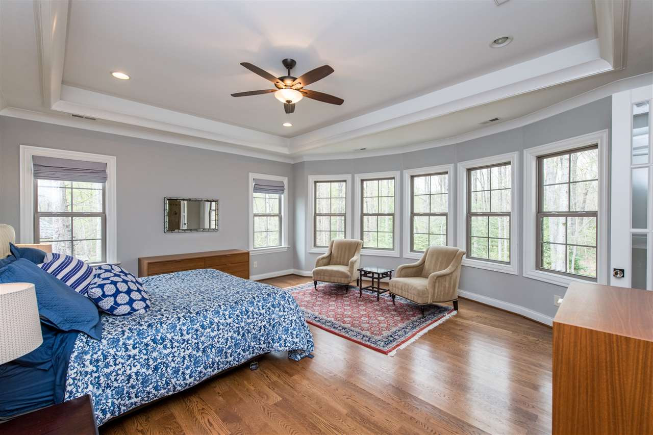 12221 Upper Creek Way Raleigh, NC 27614 - Photo 12 of 30 Large master bedroom with tray ceiling, ceiling fans, lots of windows, and hardwood floors. Master Bedroom