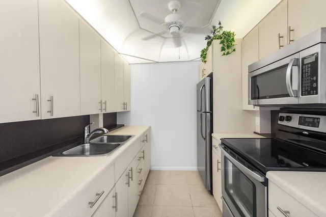 an empty room with fan and entrance