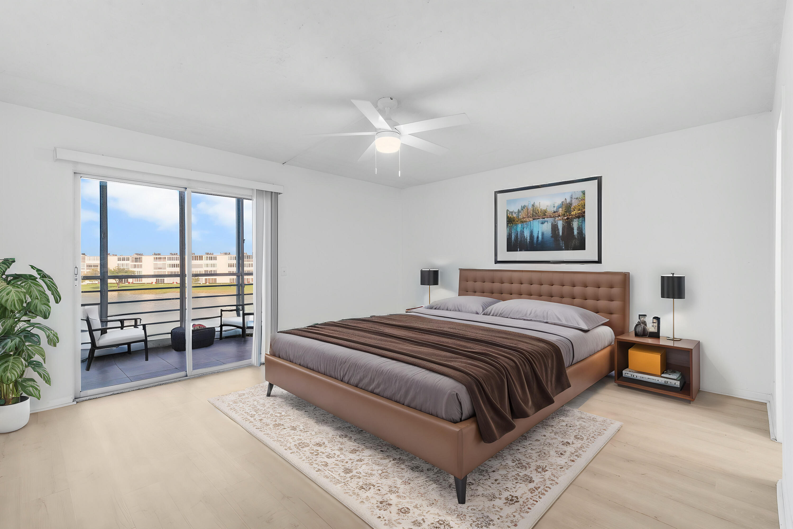 3089 Cornwall East, Unit E Boca Raton, FL 33434 - Photo 18 of 39 a bedroom with a large bed and a couch