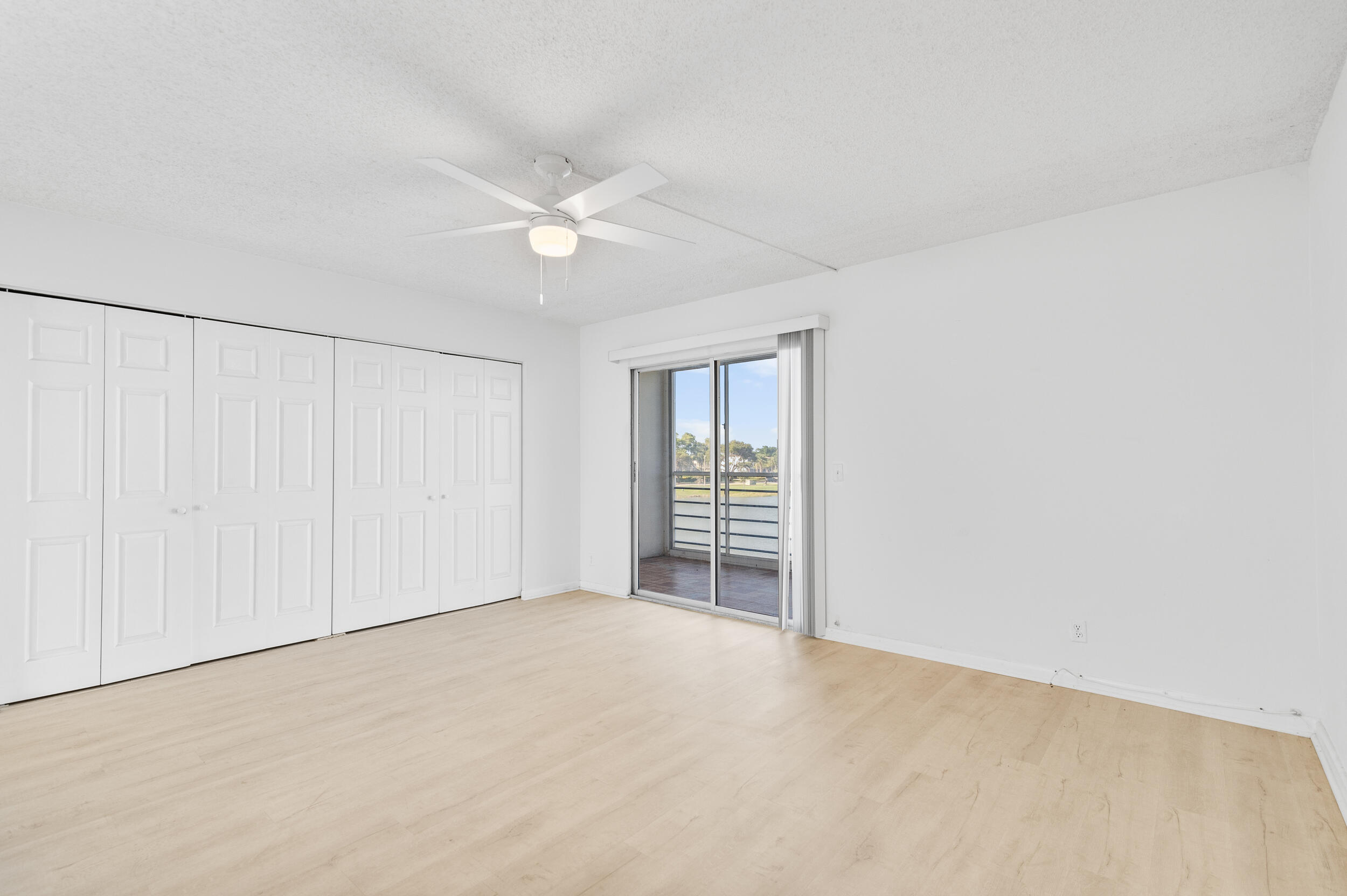 3089 Cornwall East, Unit E Boca Raton, FL 33434 - Photo 22 of 39 an empty room with windows and closet