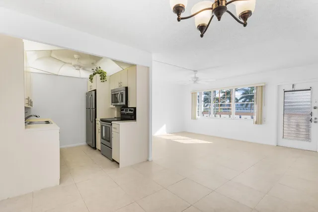 a kitchen with granite countertop a sink and steel appliances
