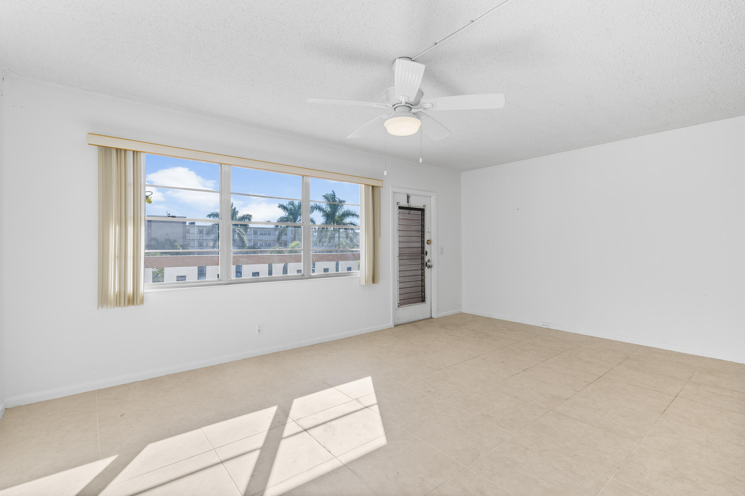 3089 Cornwall East, Unit E Boca Raton, FL 33434 - Photo 9 of 39 a view of an empty room with a window