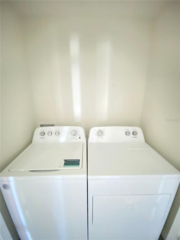 492 Hickory Course Loop Ocala, FL 34472 - Photo 25 of 28 a utility room with dryer and washer