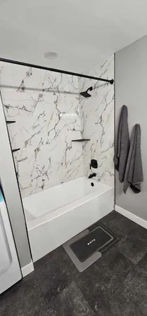 a bathroom with a bathtub and a shower