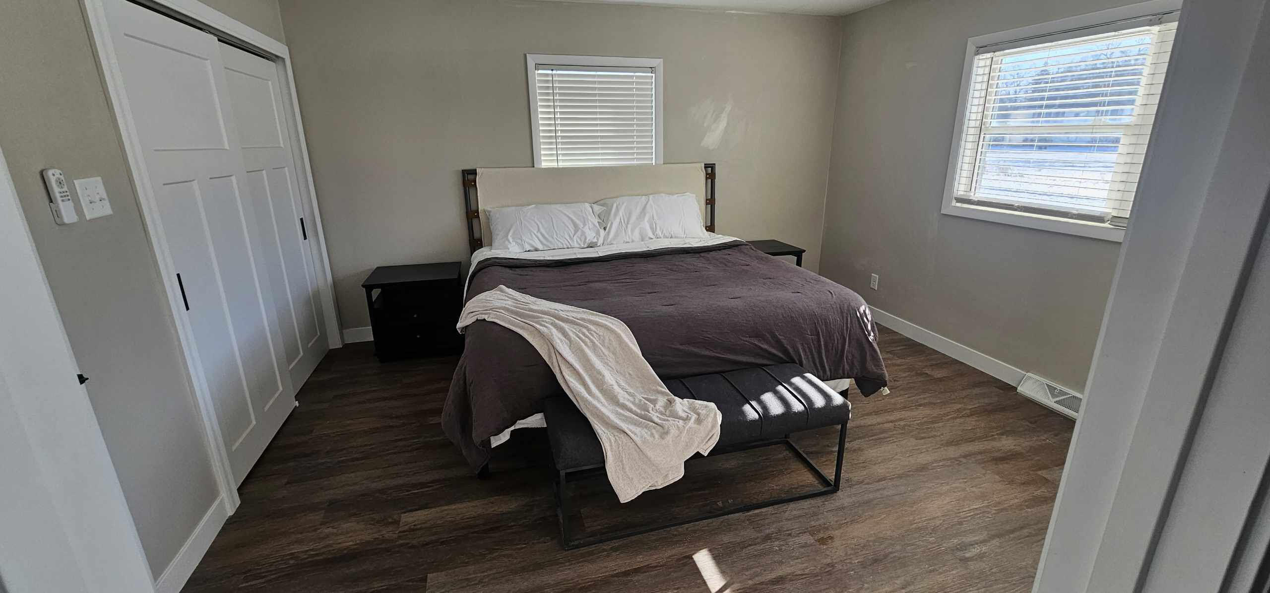 103 Michigan Street Chesterton, IN 46304 - Photo 31 of 32 a bedroom with a bed and wooden floor