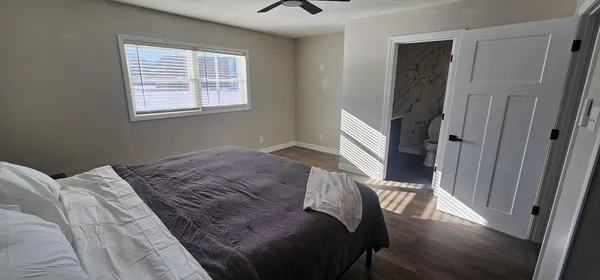 a bedroom with a bed and a window