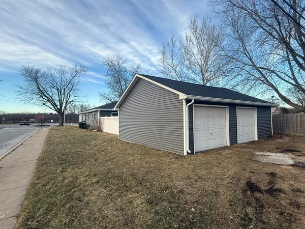 a view of a house with a yard and garage