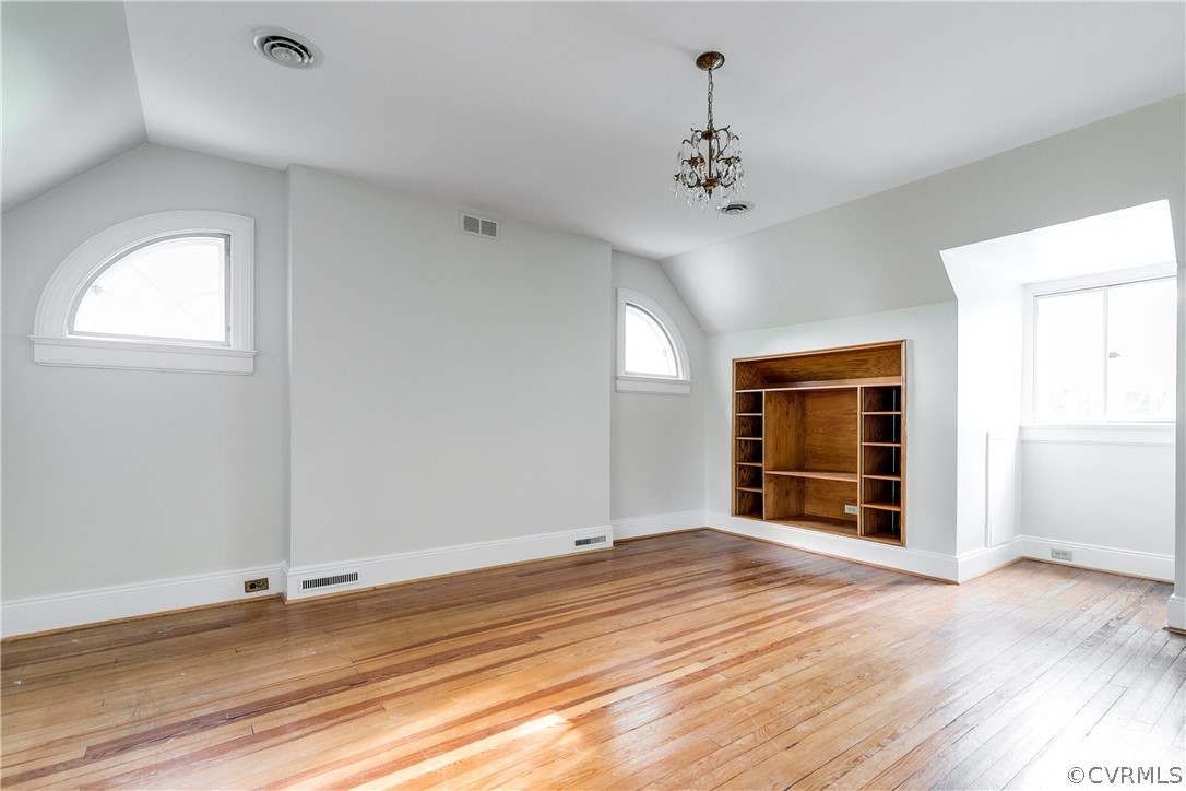 207 Nottingham Road Richmond, VA 23221 - Photo 36 of 49 an empty room with wooden floor chandelier and windows