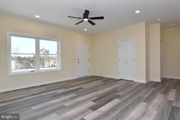 a view of a livingroom with a ceiling fan and window