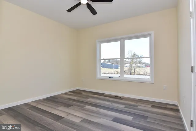 a view of a room that has a window hardwood in it