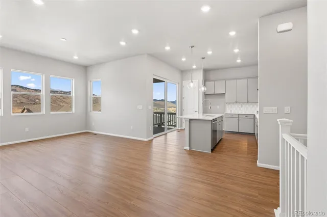 a kitchen with stainless steel appliances kitchen island granite countertop a stove a sink and a refrigerator