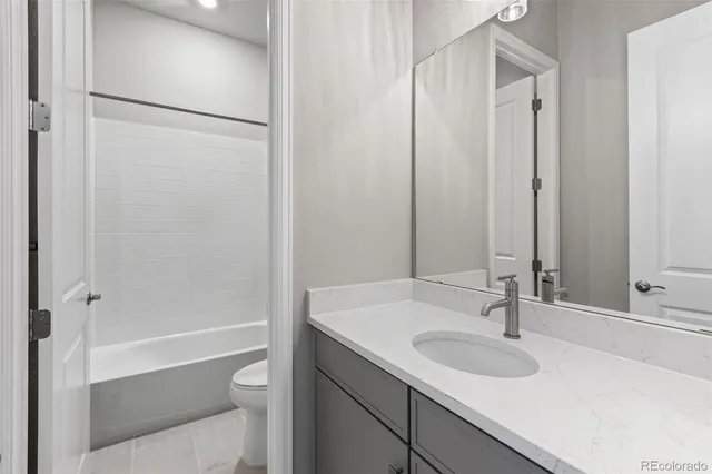 a white bath tub sitting next to a white toilet