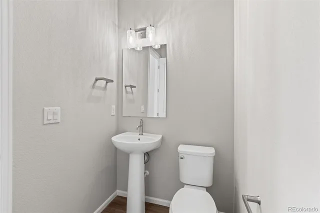 a bathroom with a sink a toilet and mirror