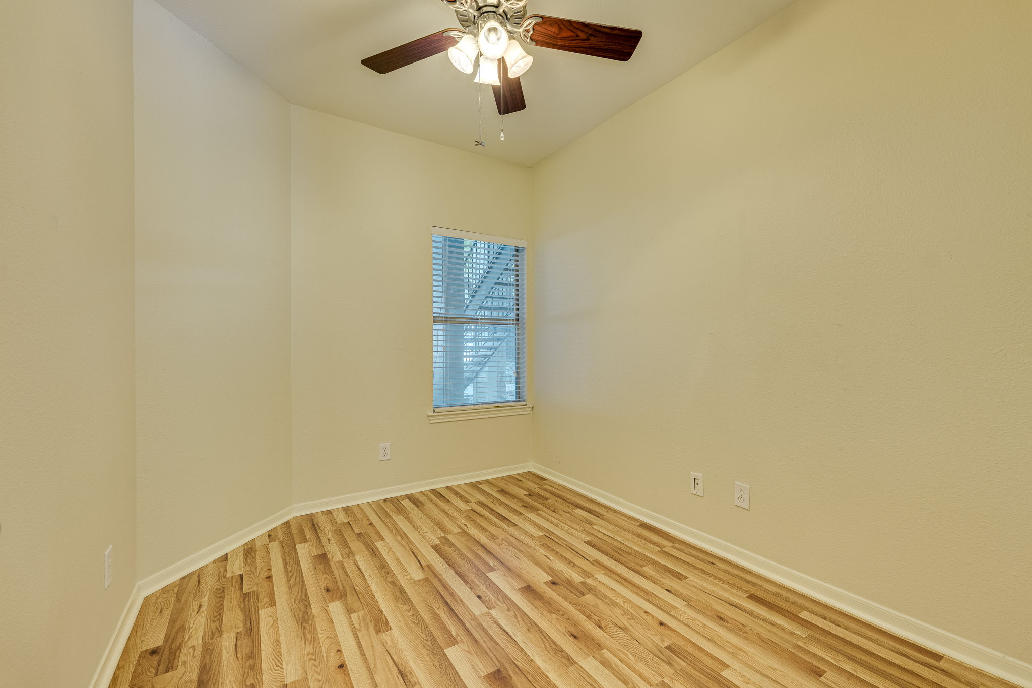 6000 Shepherd Mountain Cove, Unit 807 Austin, TX 78730 - Photo 17 of 38 Spare room featuring new wood laminate flooring and ceiling fan.