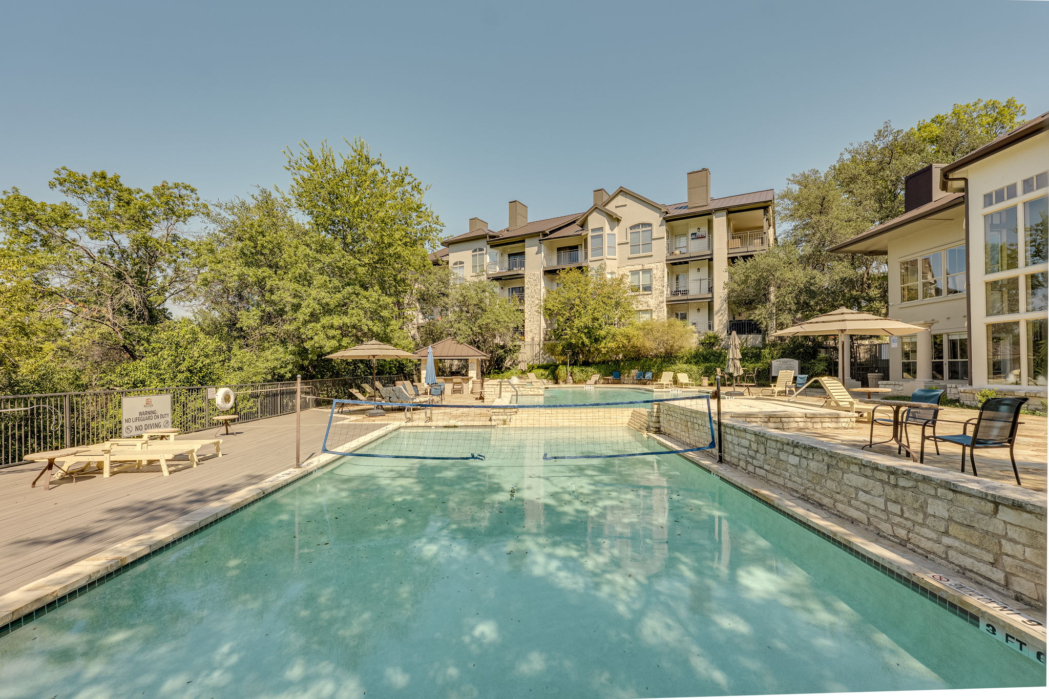 6000 Shepherd Mountain Cove, Unit 807 Austin, TX 78730 - Photo 22 of 38 Community pool area, featuring the volleyball pool and patio.