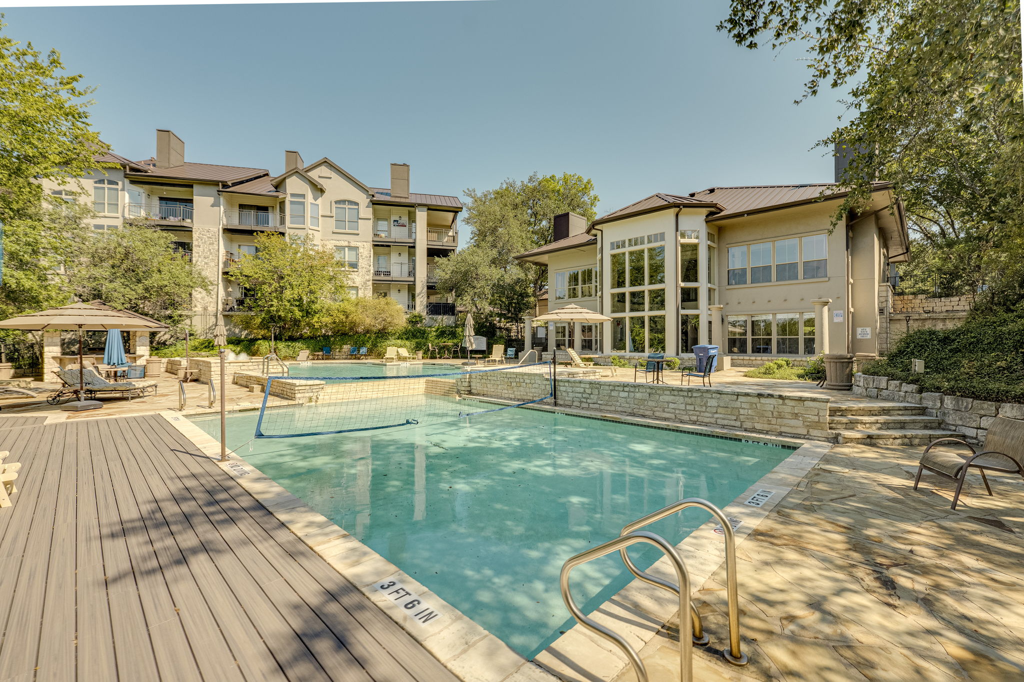 6000 Shepherd Mountain Cove, Unit 807 Austin, TX 78730 - Photo 23 of 38 Community pool area, featuring the volleyball pool and patio.