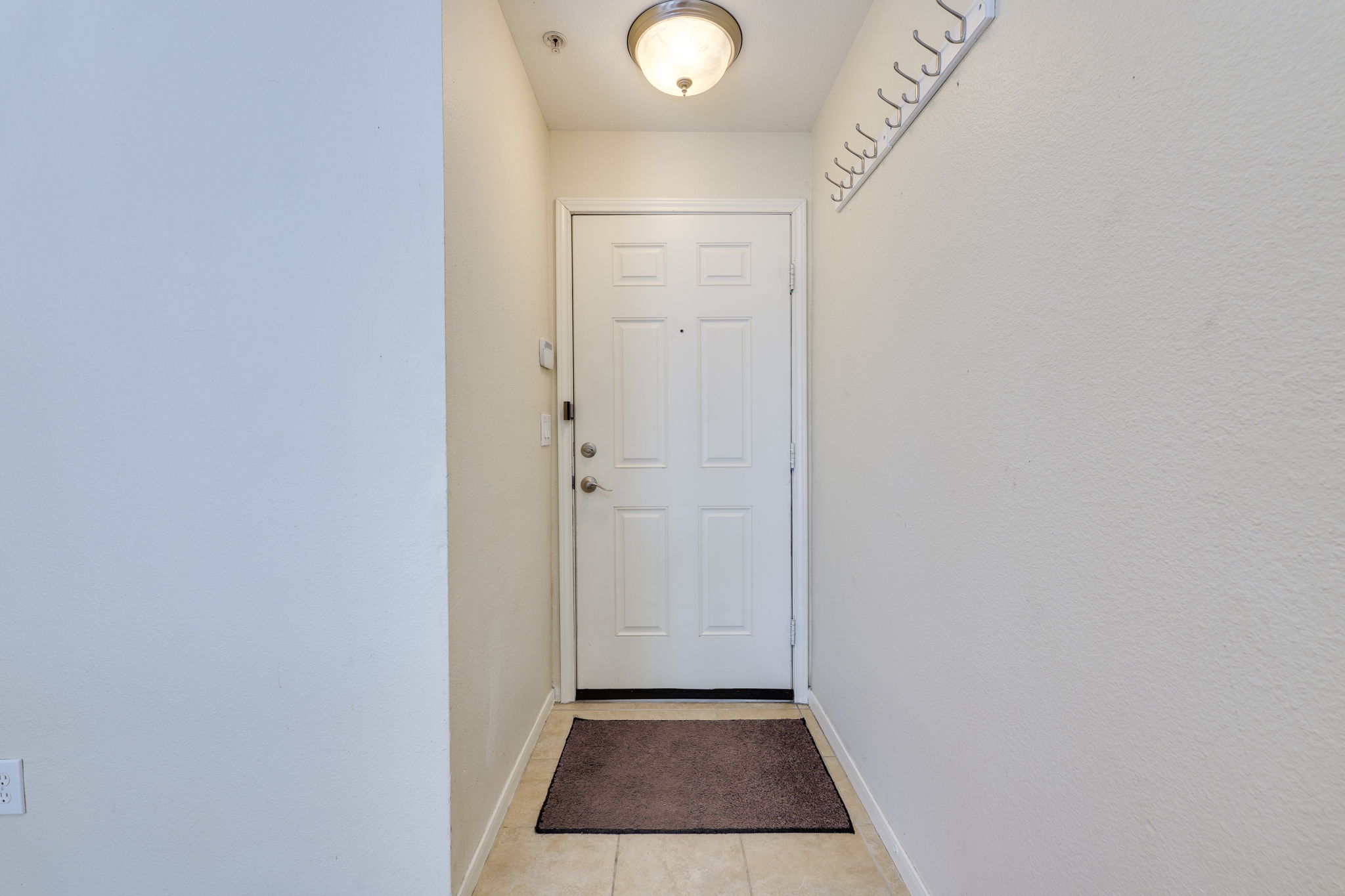 6000 Shepherd Mountain Cove, Unit 807 Austin, TX 78730 - Photo 3 of 38 Entryway featuring new wood laminate flooring.