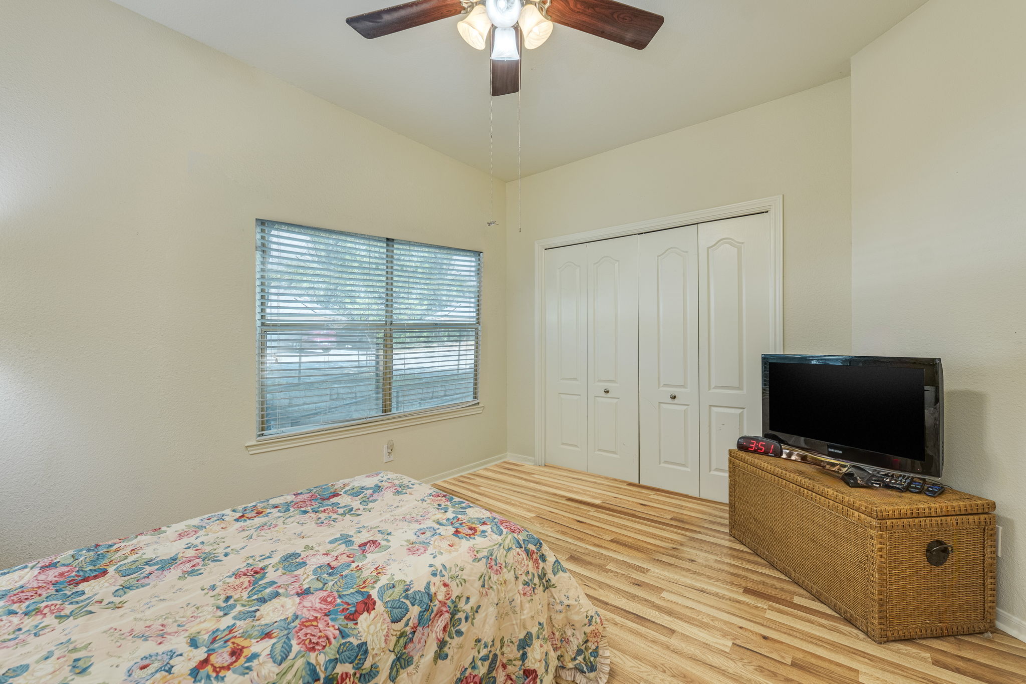 6000 Shepherd Mountain Cove, Unit 807 Austin, TX 78730 - Photo 35 of 38 1 OF 2 Bedrooms with new wood laminate floors, ceiling fan, and a closet.
