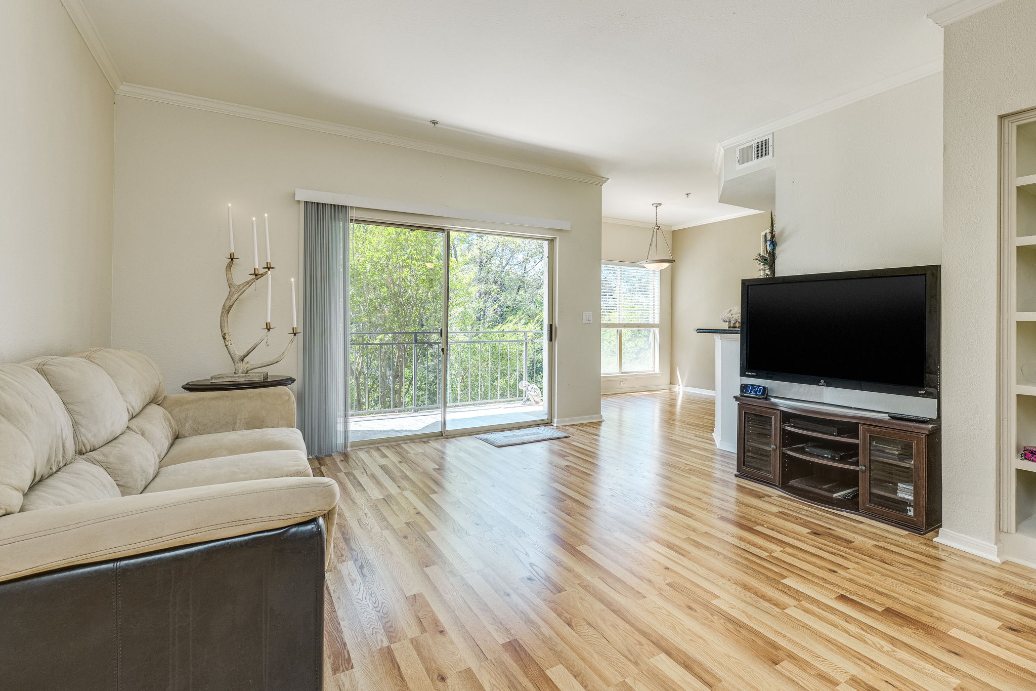 6000 Shepherd Mountain Cove, Unit 807 Austin, TX 78730 - Photo 4 of 38 Living room with new wood laminate floors. Sliding doors take you to terrace overlooking pool and spa area.