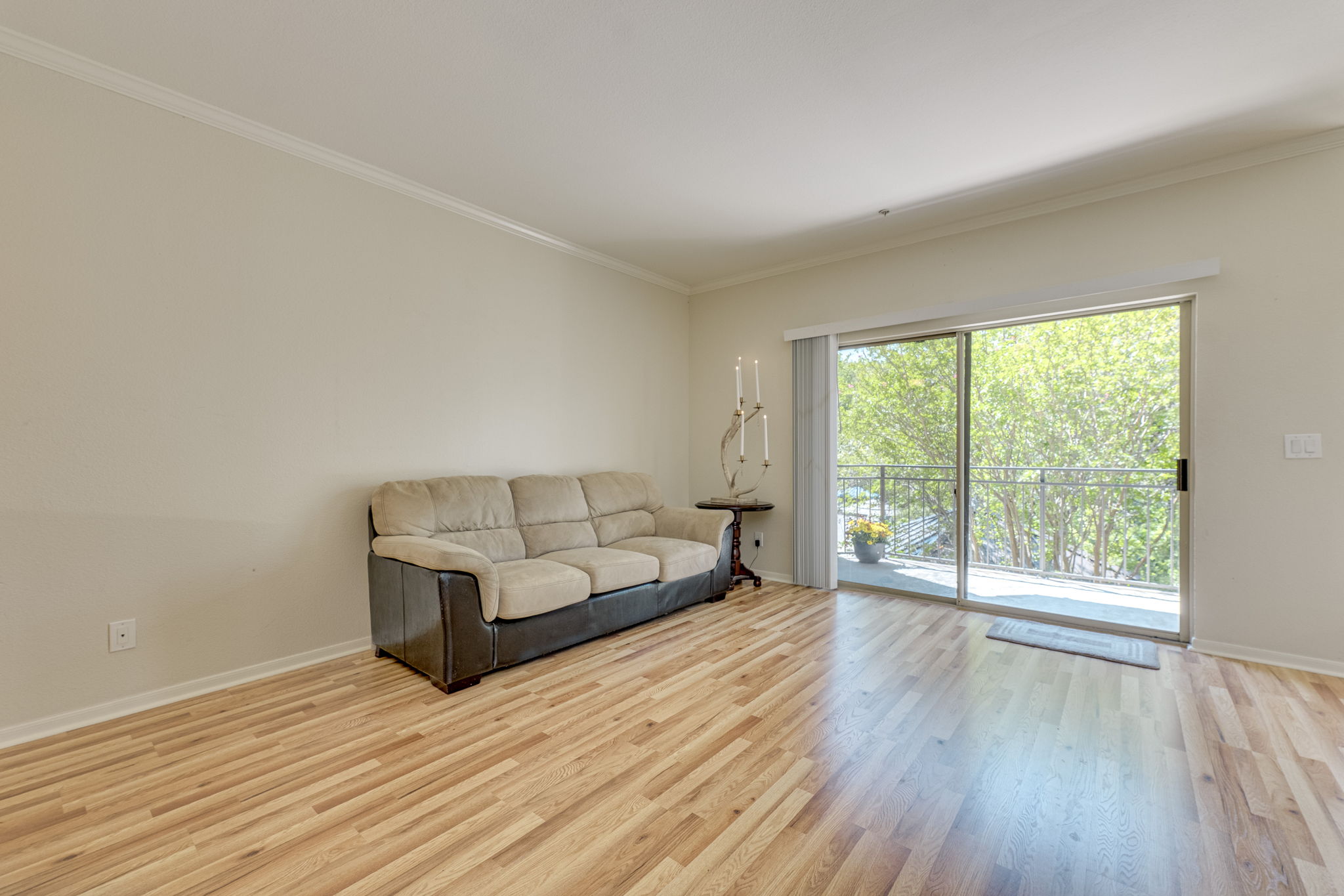 6000 Shepherd Mountain Cove, Unit 807 Austin, TX 78730 - Photo 5 of 38 Living area featuring new wood laminate flooring. Patio doors take you to terrace that overlooks pool area.