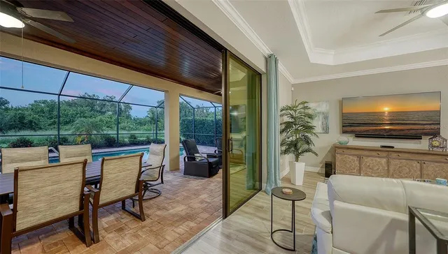 a kitchen with a table chairs stove and flat screen tv