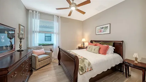 a bathroom with a granite countertop sink a toilet a mirror and shower