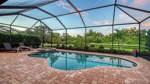 a living room with furniture and large windows