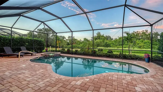 a living room with furniture and large windows