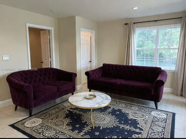 a living room with furniture and a rug