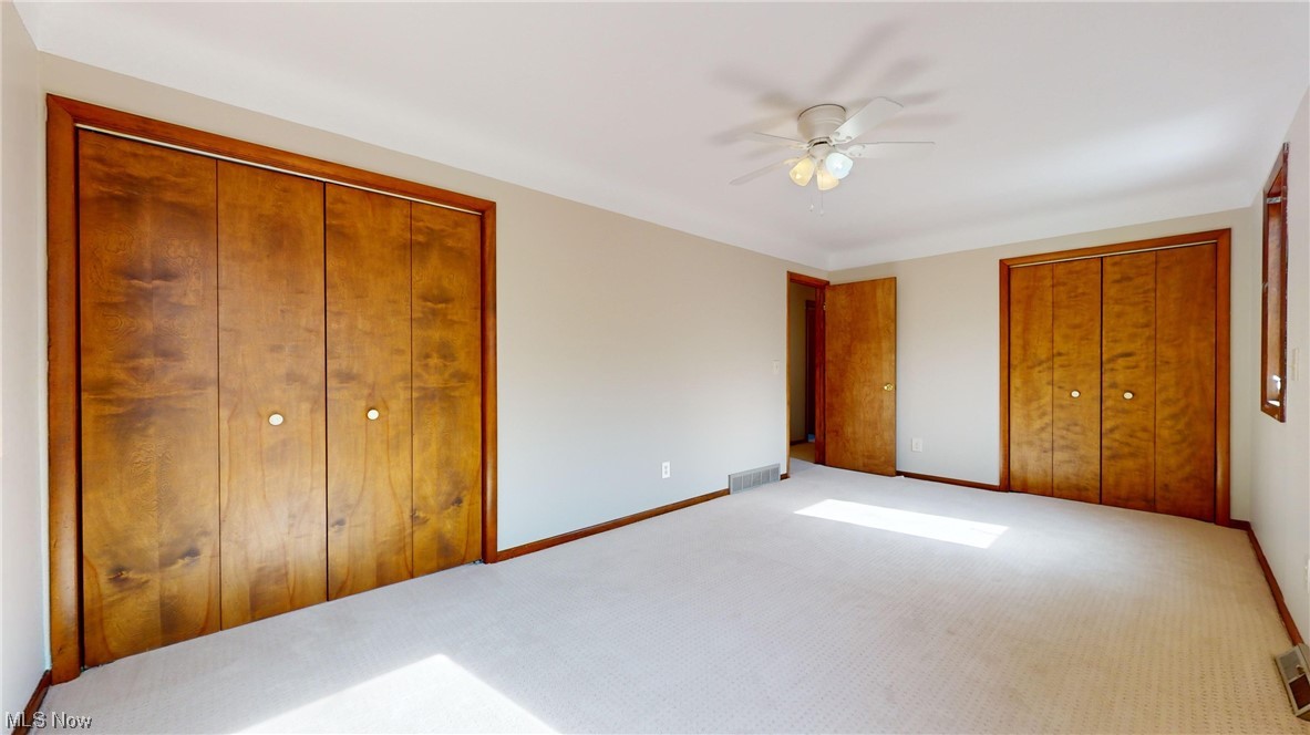 11110 Kile Road Chardon, OH 44024 - Photo 26 of 35 Carpeted bedroom featuring ceiling fan and two large closets