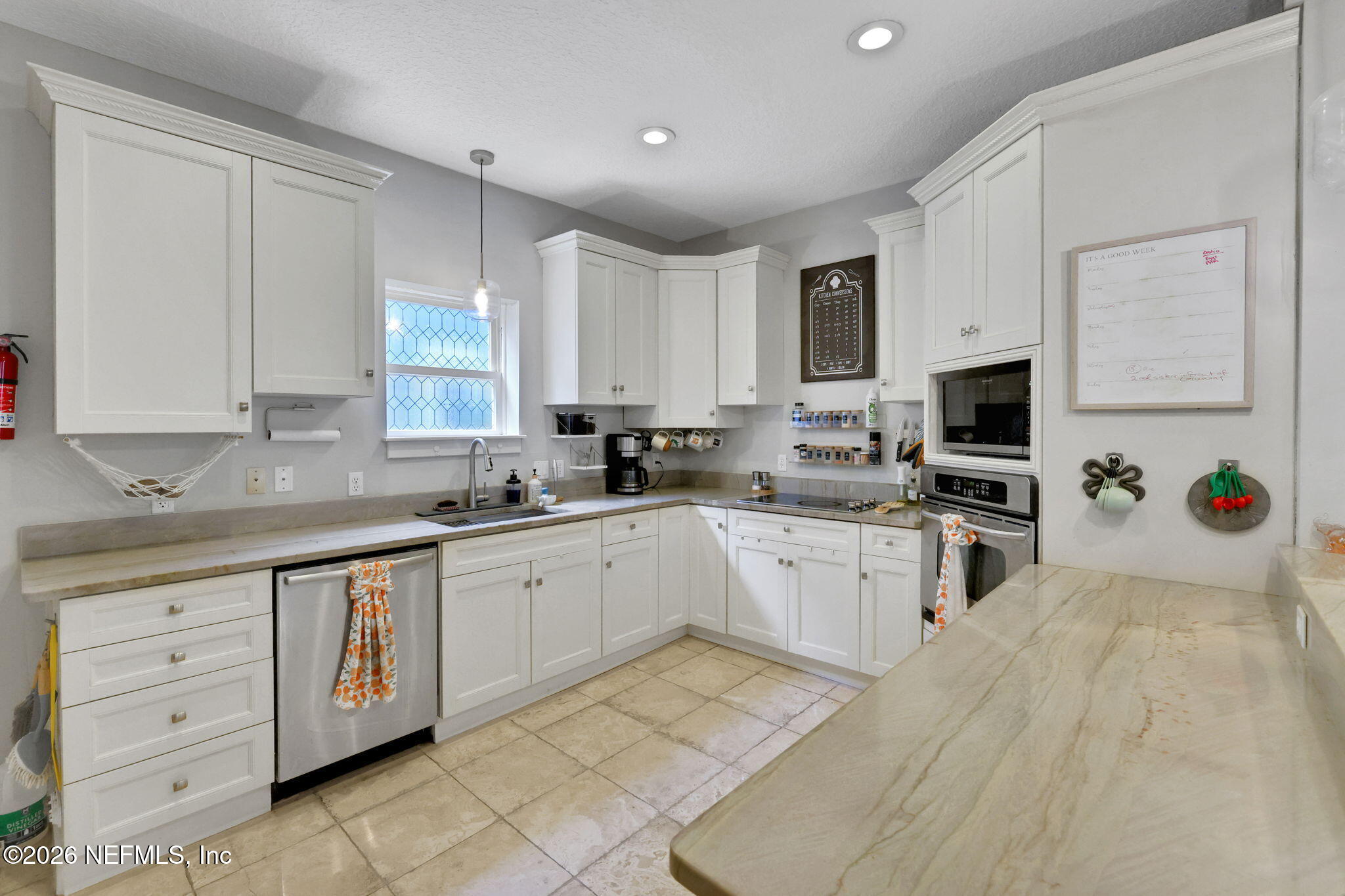 2837 Post Street Jacksonville, FL 32205 - Photo 25 of 70 a kitchen with granite countertop white cabinets stainless steel appliances a sink and a window