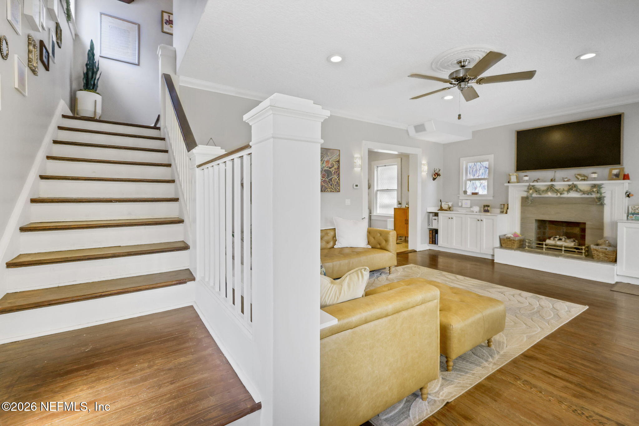 2837 Post Street Jacksonville, FL 32205 - Photo 29 of 70 a view of a livingroom with a fireplace a flat screen tv and a ceiling fan