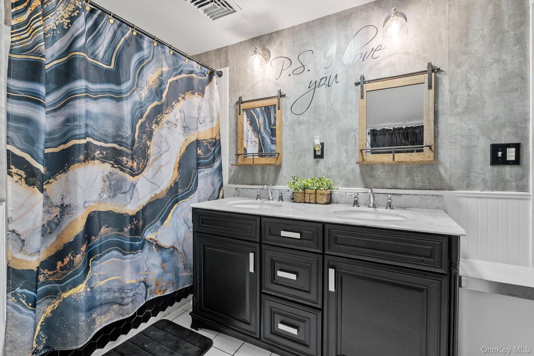 168 Fostertown Road Newburgh, NY 12550 - Photo 32 of 38 Bathroom with curtained shower, light tile patterned floors, and double vanity
