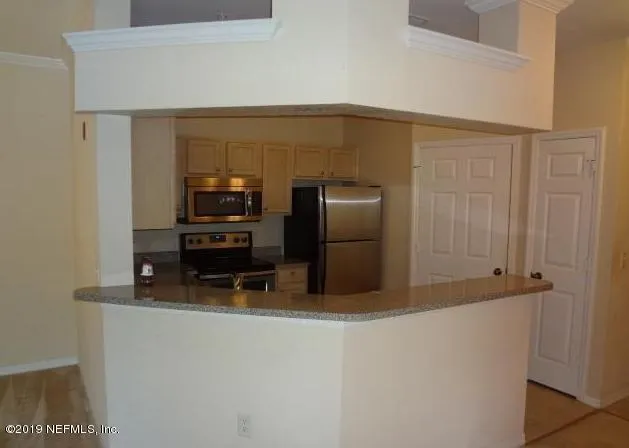a kitchen that has a refrigerator and a stove