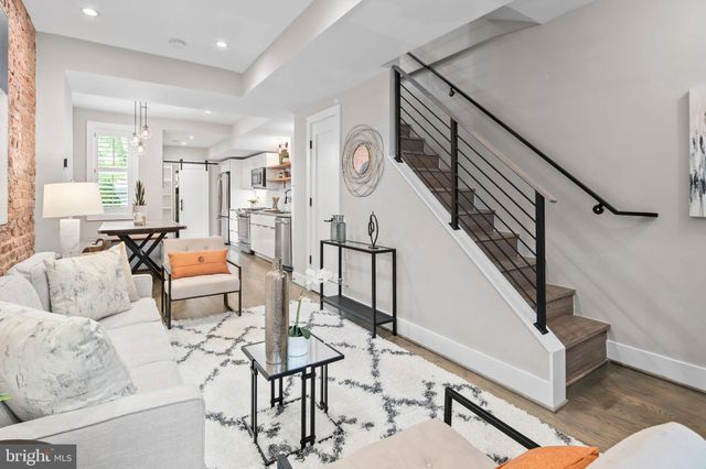 a view of a hallway with windows and stairs