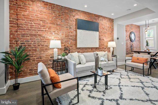a living room with furniture and a lamp