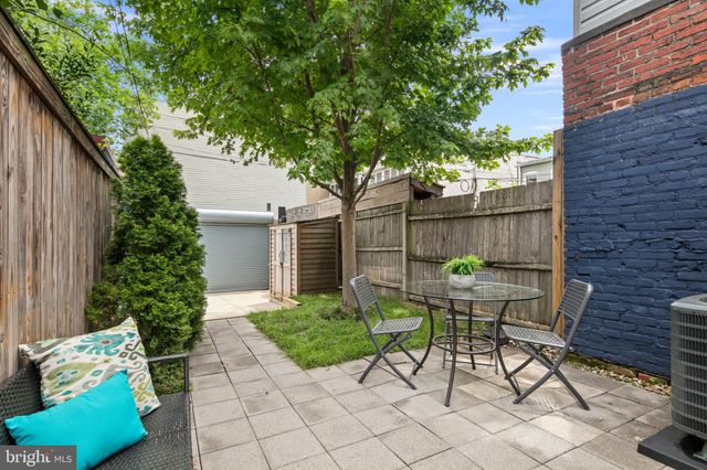 a backyard with plants and outdoor seating