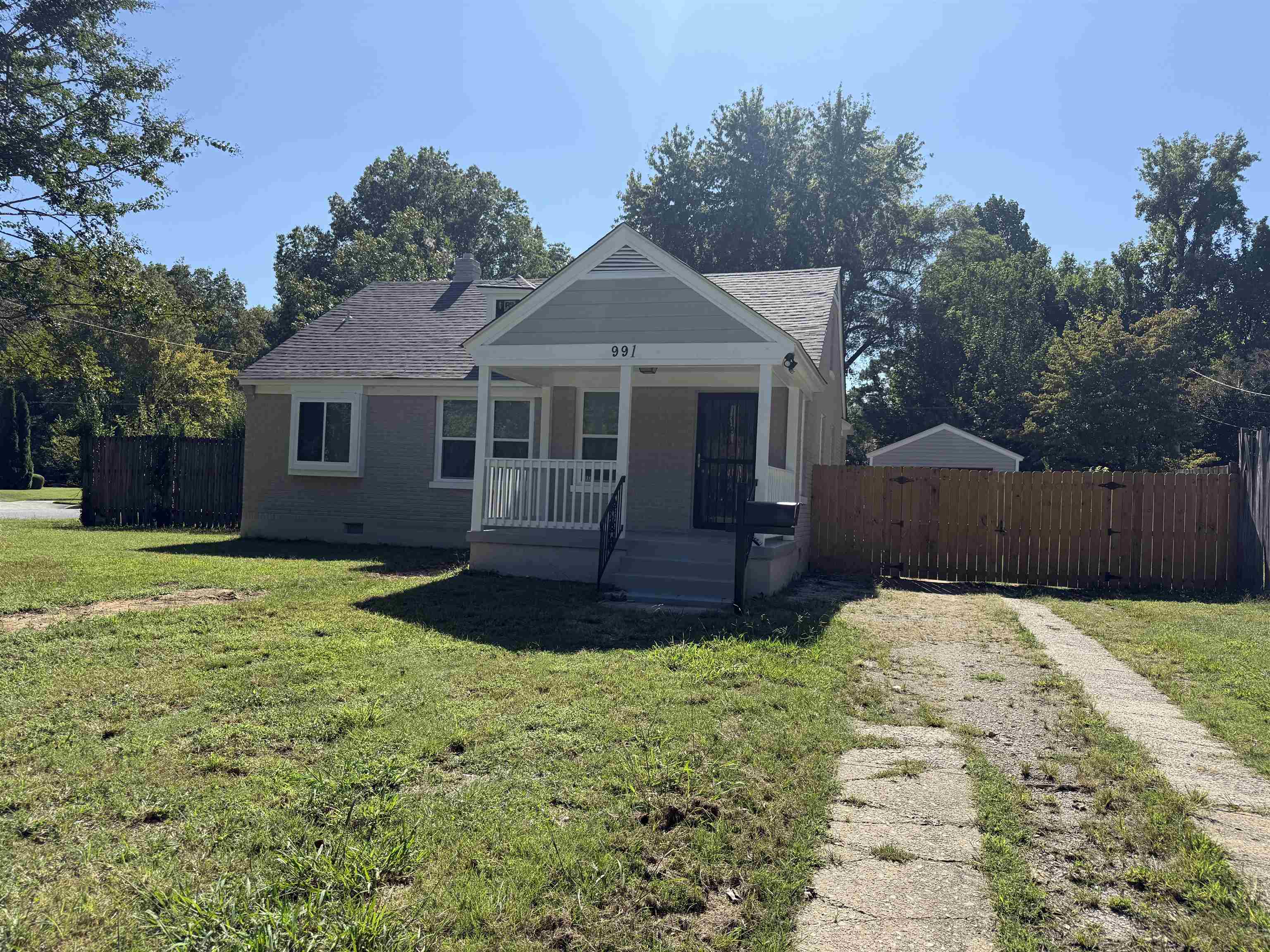 Bungalow-style house with a porch, a shingled roof, and crawl space