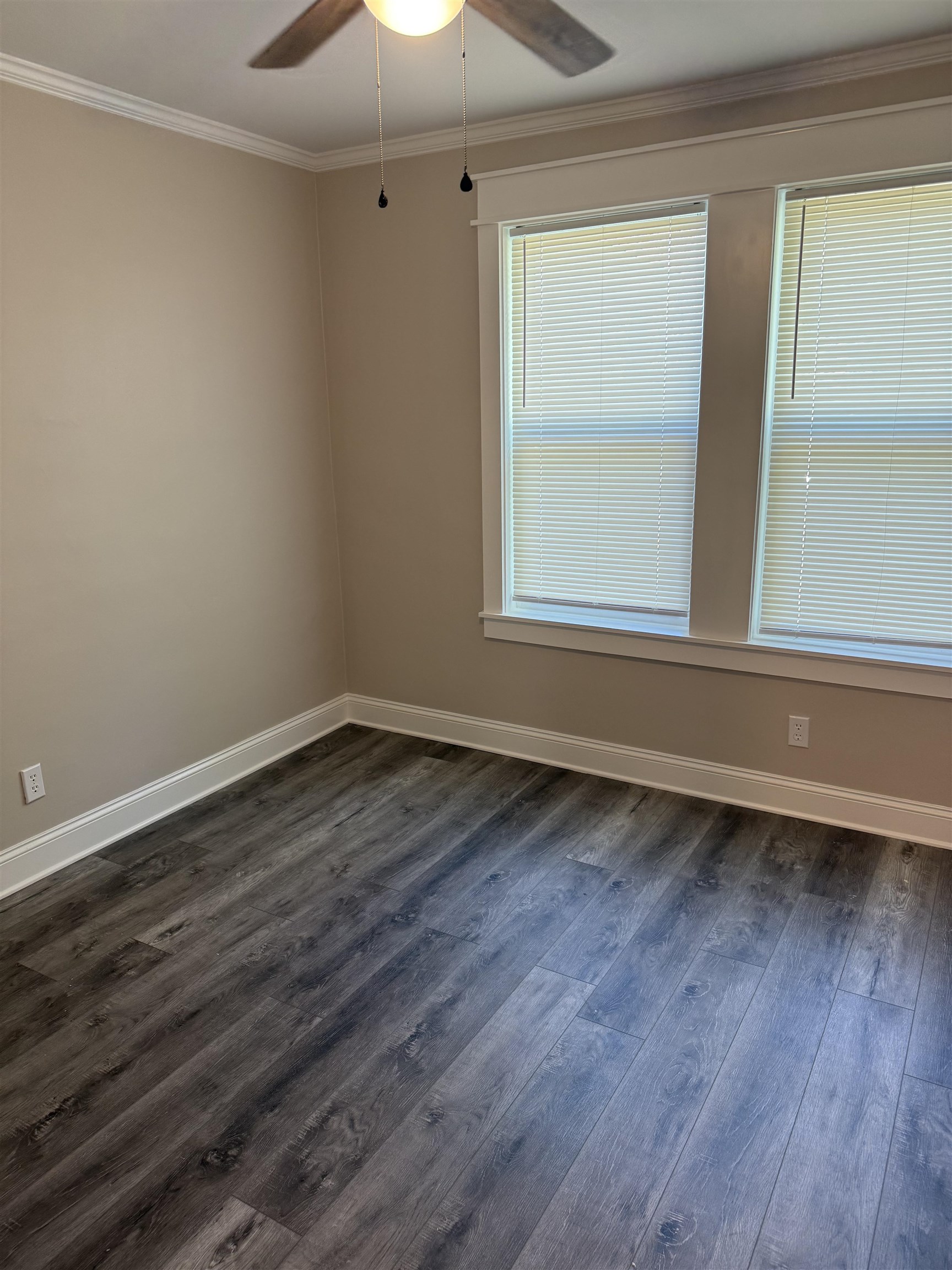 991 McEvers Road Memphis, TN 38111 - Photo 16 of 28 Empty room featuring ornamental molding, dark wood-style floors, and a ceiling fan