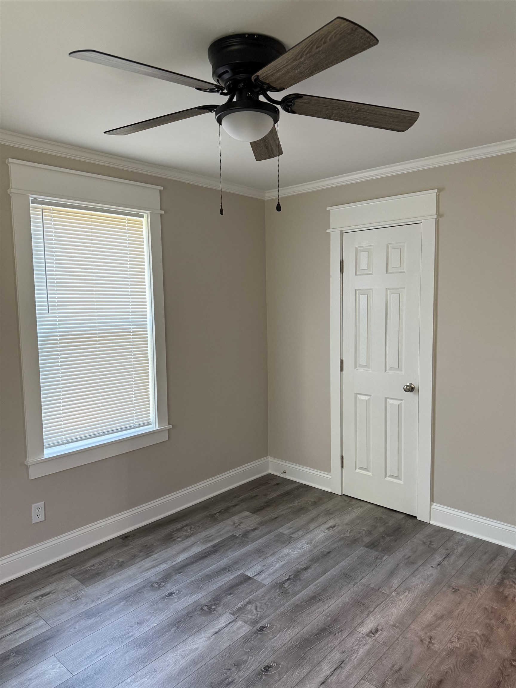 991 McEvers Road Memphis, TN 38111 - Photo 19 of 28 Empty room with ornamental molding, wood finished floors, and a ceiling fan