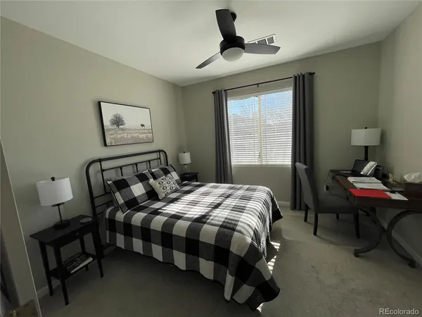 a bedroom with a bed wooden floor and window