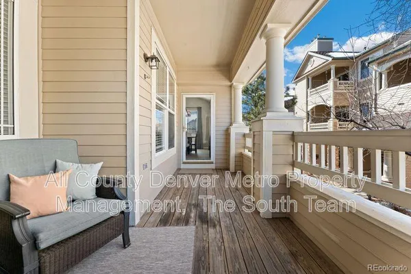 a view of a balcony with chairs and wooden floor