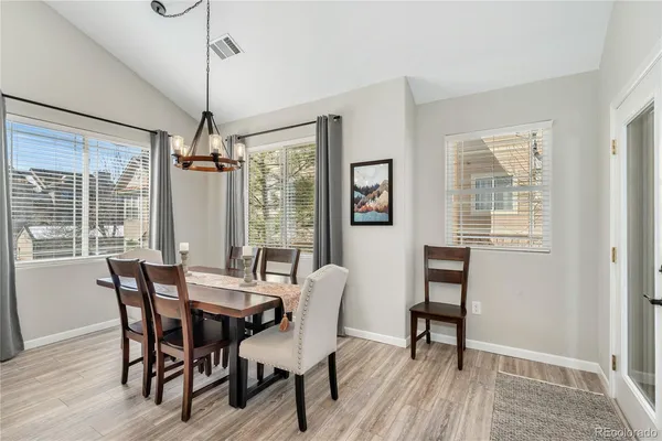 a view of a dining room with furniture window and wooden floor