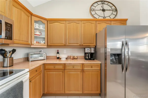 a kitchen with stainless steel appliances granite countertop a sink a stove and refrigerator