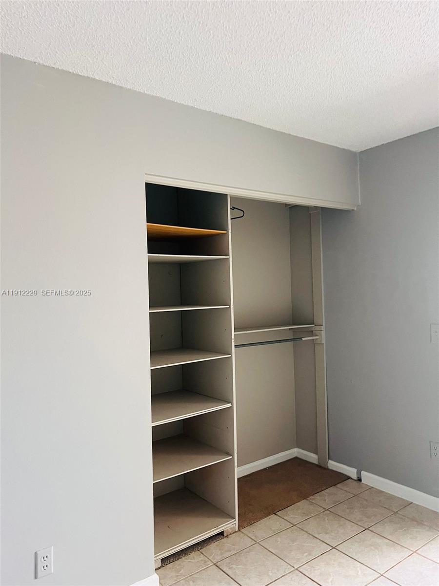 5130 Elmhurst Road, Unit H West Palm Beach, FL 33417 - Photo 14 of 15 a view of an empty room with empty racks