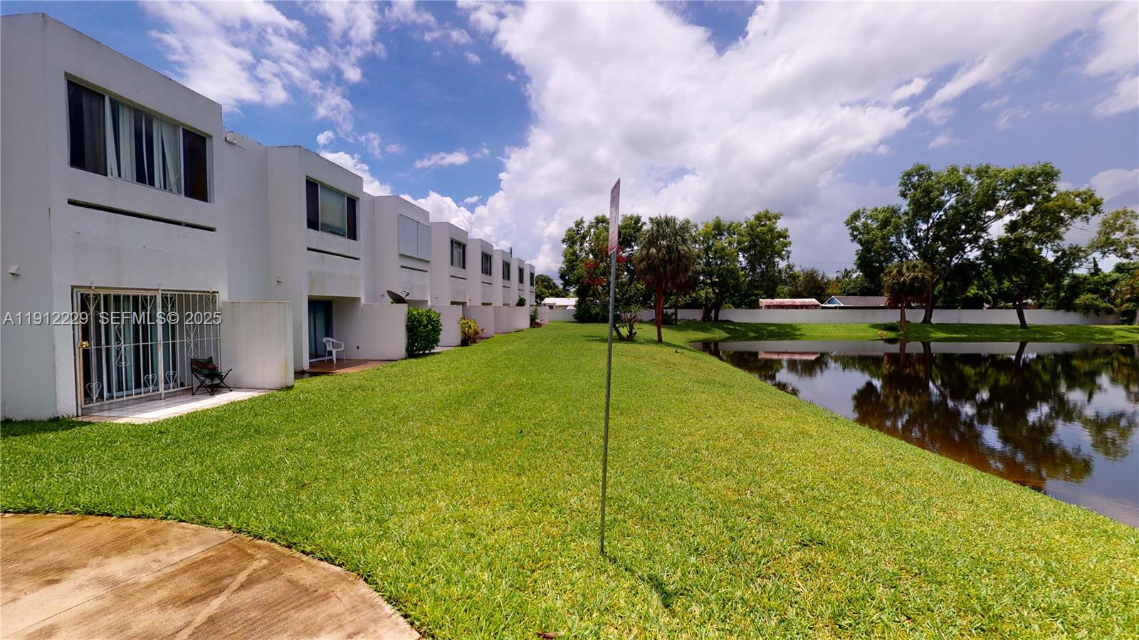 5130 Elmhurst Road, Unit H West Palm Beach, FL 33417 - Photo 3 of 15 a view of a house with a yard