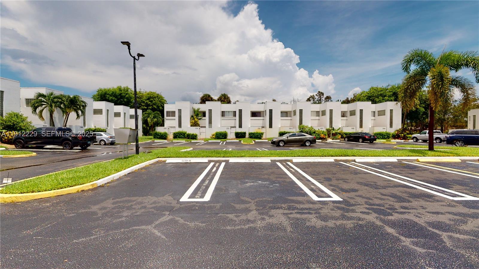 5130 Elmhurst Road, Unit H West Palm Beach, FL 33417 - Photo 5 of 15 a view of a city street and houses
