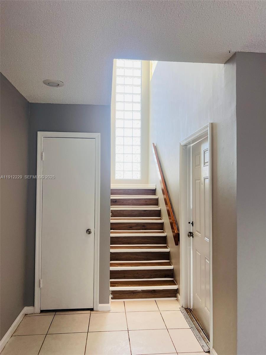 5130 Elmhurst Road, Unit H West Palm Beach, FL 33417 - Photo 10 of 15 an entryway with stairs and a window
