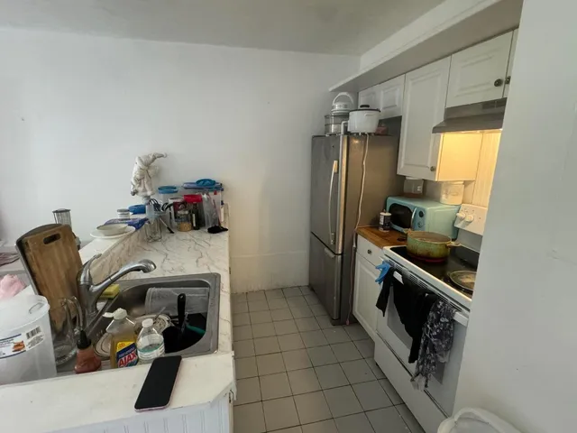 a kitchen with a sink appliances and cabinets